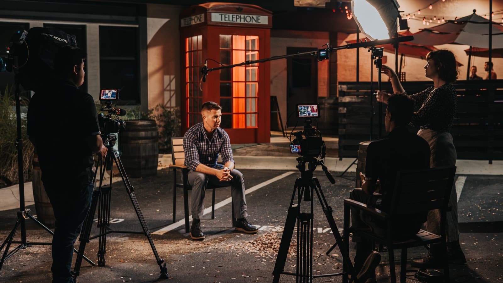 A Skytona interview set at night with two cameras, a boom mic, and lighting.